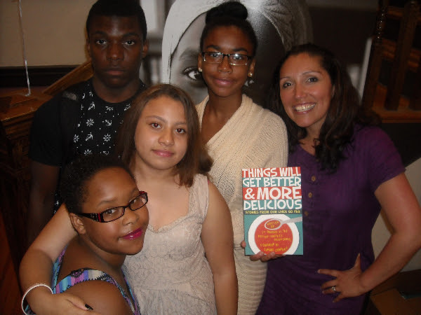 Author and partner teacher Jennifer De Leon poses with her students during Monday night's release party for Things Will Get Better and More Delicious.
