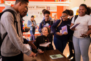 Julia Alvarez signing books for students.
