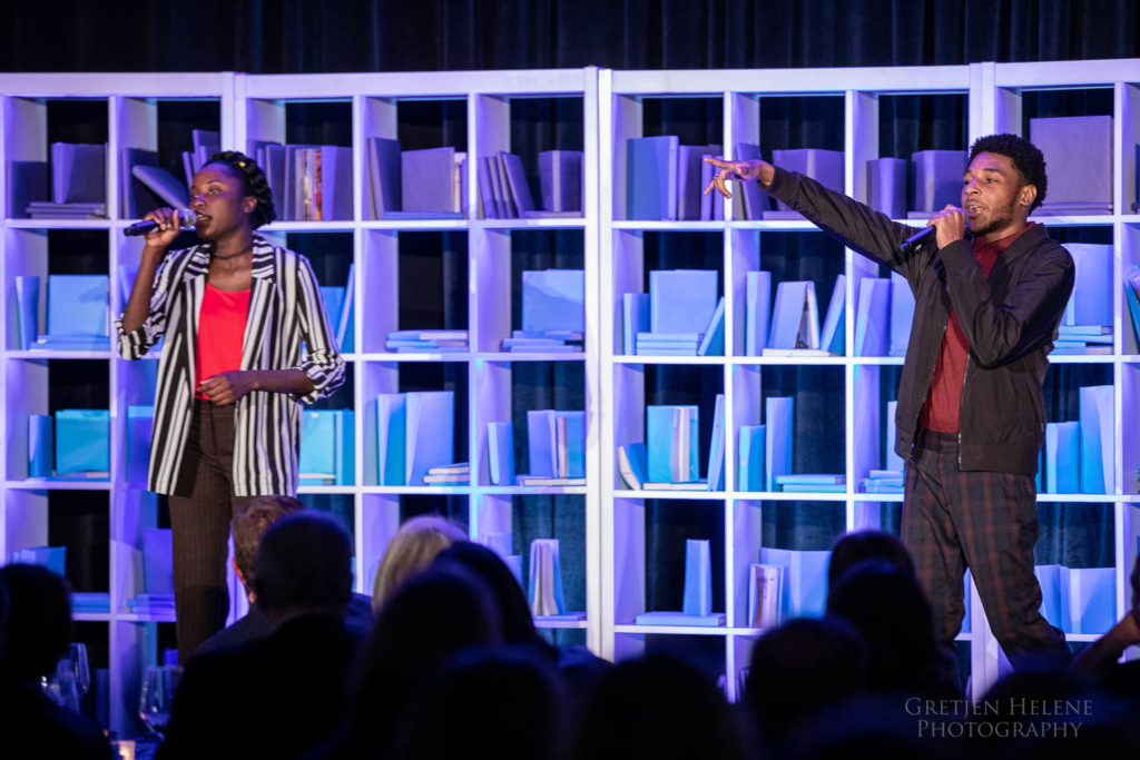 Students Robentina and Victor performing a song onstage.