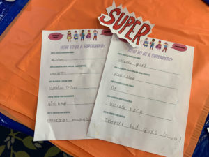 Two students write descriptions of what it takes to be a superhero.