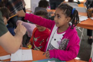 A student shares their comic strip ideas at the Boston Book Festival.