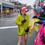 Erin stops to chat with supporters while running in the 2018 Boston Marathon© for 826 Boston.