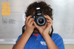 A student from the Lilla G. Frederick Pilot Middle School takes a photo for the young author book project.