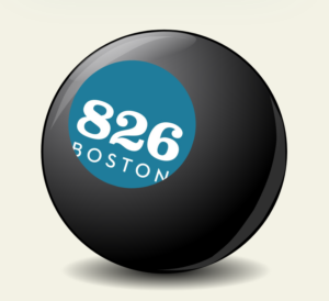 PIctured is a magic 8 ball with the spot where the number 8 usually goes replaced with the blue logo for 826 Boston
