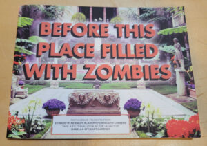 On a table is a copy of the student-authored publication "Before the Place Filled With Zombies"
