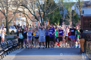 826 Boston Half Half Half Half Half Marathon starting line. All the participants are cheering with their hands up.